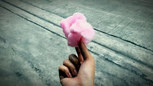 Close-up of hand holding cotton candy