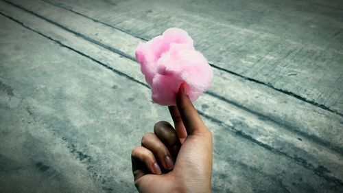 Close-up of hand holding cotton candy