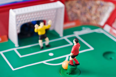 Close-up of figurine soccer field on table