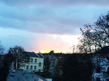 Buildings against cloudy sky