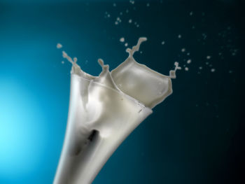 Close-up of water splashing on blue background