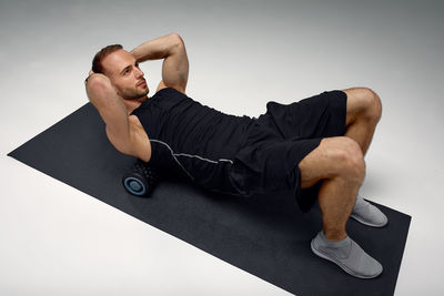 Low section of man exercising in gym