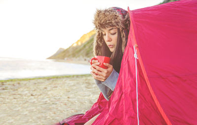 Young woman using mobile phone at beach