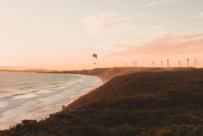 Scenic view of beach against sky during sunset