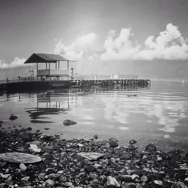 water, sea, sky, beach, cloud - sky, built structure, shore, horizon over water, architecture, cloudy, nature, building exterior, rock - object, tranquility, tranquil scene, scenics, beauty in nature, pier, cloud, day