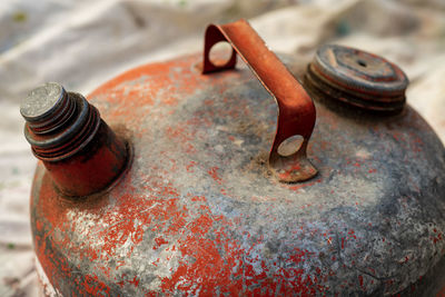 Weathered metal gas can red peeling off paint