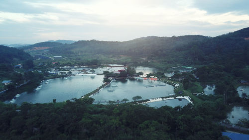 High angle view of river amidst trees against sky