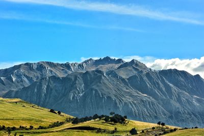 Scenic view of mountain range against blue sky