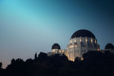 Low angle view of illuminated buildings against clear sky