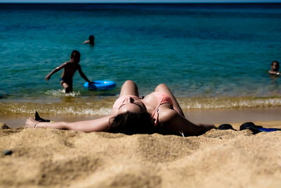 Friends relaxing on shore at beach