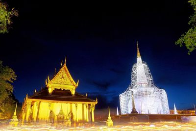 Illuminated temple against sky at night