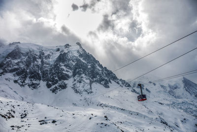 Ski lift on snow covered mountain