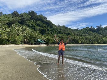 Rear view of man standing in sea
