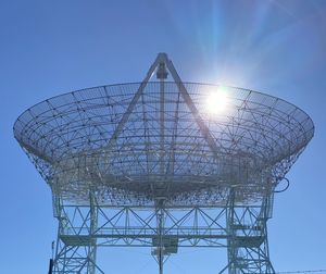 Low angle view of communications tower against sky