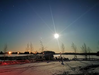 Scenic view of snow covered field against bright sky