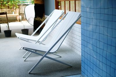 Empty chairs and tables on tiled floor