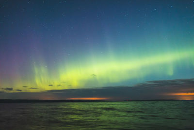 Scenic view of sea against northern lights