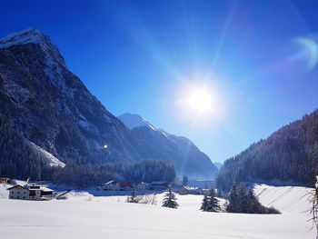 Scenic view of snowcapped mountains against blue sky