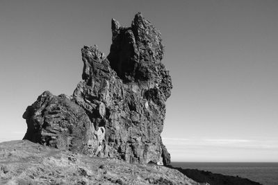 Low angle view of rock formation against clear sky