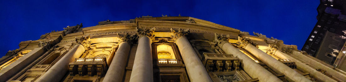 Low angle view of illuminated building against sky at night