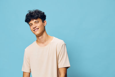 Portrait of young man standing against clear sky