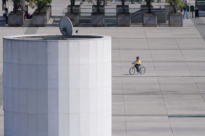 Man riding bicycle on street in city