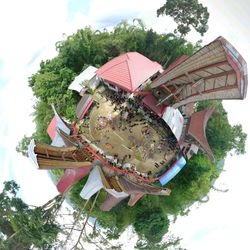 Low angle view of carousel against sky