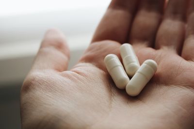 Close-up of human hand holding pills 