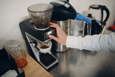 High angle view of woman pouring coffee