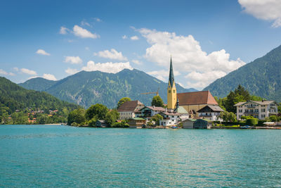 Scenic view of sea and buildings against sky