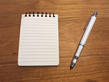 Close-up of pen and book on table