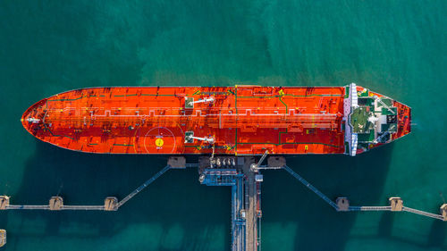 Aerial view tanker ship unloading at port, business import export oil with tanker ship