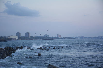 Scenic view of sea and buildings against sky