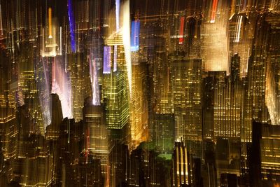 Aerial view of illuminated buildings in city at night