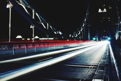 Light trails on bridge in city at night