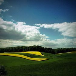 Scenic view of landscape against cloudy sky