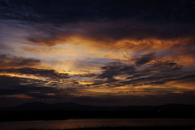 Scenic view of dramatic sky during sunset