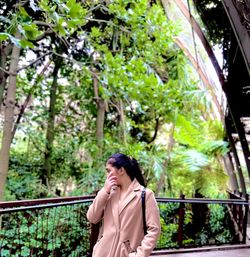 Portrait of beautiful woman standing upon nature