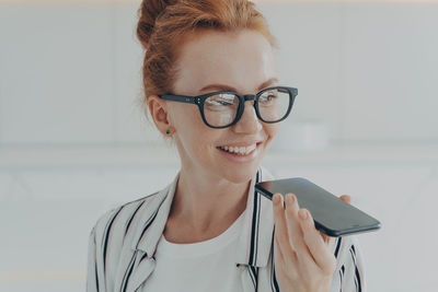 Businesswoman talking on phone at office