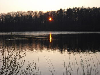 Scenic view of calm lake at sunset