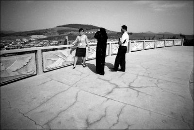 Rear view of people looking at sea