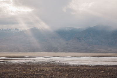 Scenic view of mountains against cloudy sky