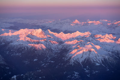 Scenic view of snowcapped mountains against sky during sunset