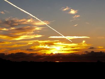 Silhouette landscape against scenic sky