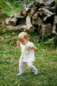 Full length of cute boy standing on grass