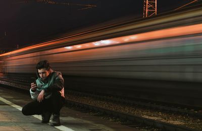 Full length of train on railroad station platform at night