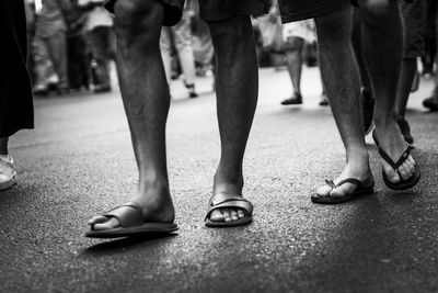 Low section of people standing on street