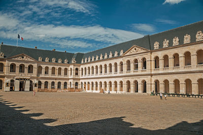 Inner courtyard of the les invalides palace with old cannons in paris. the famous capital of france.