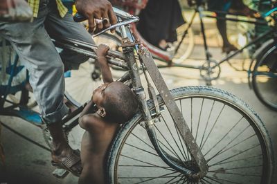 Low section of man with bicycle on street