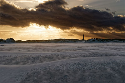 Scenic view of beach against sky during sunset